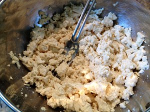 Mash tofu with the back of a fork.