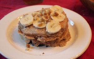 This is two pancakes, layered with bananas and chopped walnuts.