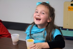 Another classmate creating a pumpkin mustache.