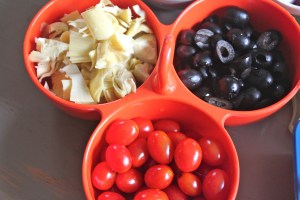 Chopped artichoke hearts, cherry tomatoes, and sliced black olives.