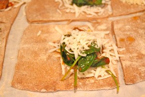 Layer your cheese, and sausage/spinach mixture on half.