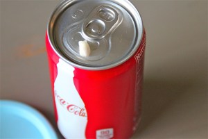 Seems innocent enough. A cute little can of Coke and a cute little clean tooth.